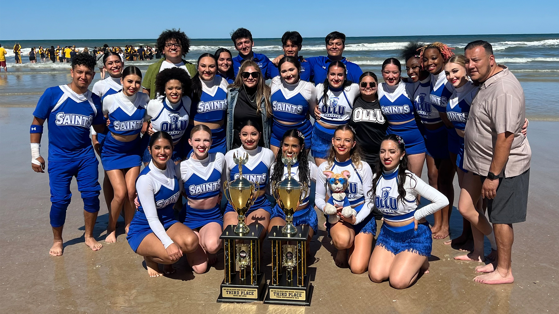 The spirit teams pose with their trophies.